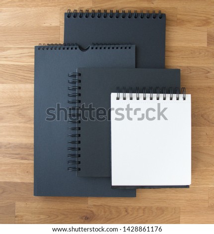Set of white paper, sketchbooks, black albums on white background