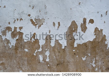 Old and peeled of white painting cracked on the brown color cement wall surface for art background and textured photo.