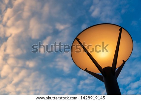 The lamp lighting with blue sky and cloud
