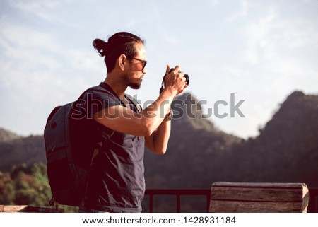 Asian men backpacks and traveler walking together and happy are taking photo on mountain  ,Relax time on holiday concept travel