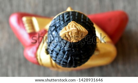 Radius of flame of Buddha statue carved from wood, with yellow gold with black hair.