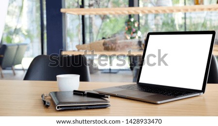 Comfortable workplace with blank screen laptop