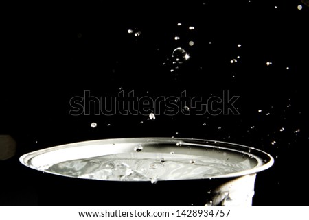 Ice water splashing in black background