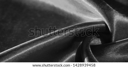 Texture, background, pattern, silk fabric in black. This adorable, soft and shiny fabric has a smooth mink surface, perfect for creating your projects. Royalty-Free Stock Photo #1428939458