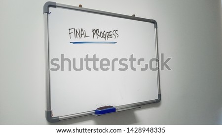 white board on a wall. with a final progress caption 