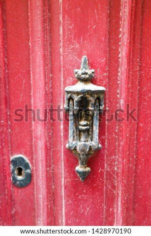 old vintage door handle on red wooden door closeup, Valletta, Malta