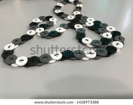 Homemade button lanyard black, white and grey color.