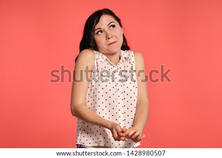 Studio shot of a beautiful girl teenager posing over a pink background.
