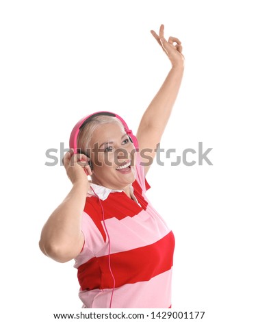 Mature woman enjoying music in headphones isolated on white