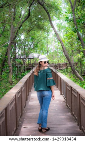 Women fashion tourists wooden bridge In the Asian mangrove forest study route