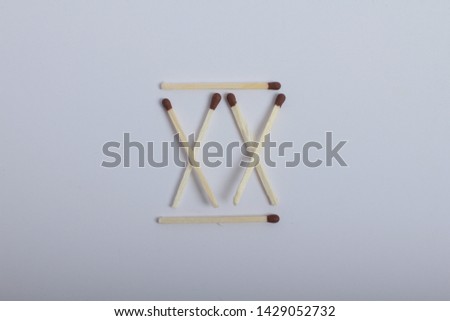 Roman numerals from matches on white background
