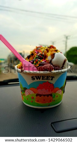 A cup ice cream in the car