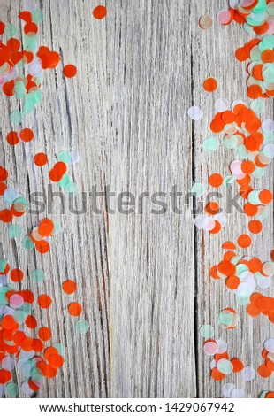 Three-color paper confetti on a white wooden background. Irish, india and Cinu, independence day concept. patriotism and freedom, the joy of the national holiday