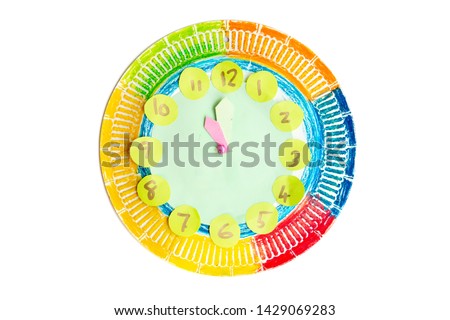 Colorful child handwork clock pointing at 11 o'clock, isolated on white background