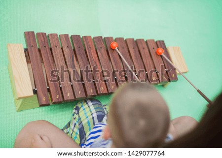 Playing a xylophone musical instrument.