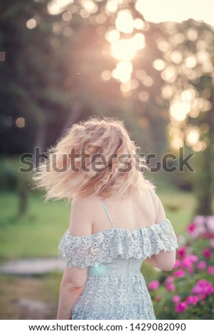 girl with a bouquet of beautiful peony flowers outdoors
