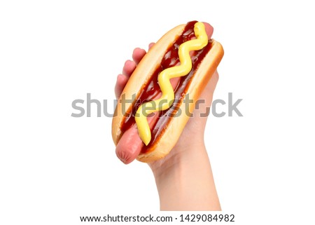 Hot dog in woman hand isolated on white background. Copy space.