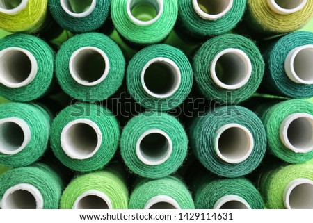 Many colorful sewing threads as background