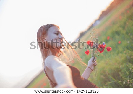 cheerful girl on the field. portrait. concept of freedom and independence