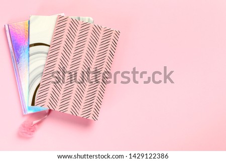 Top view of notebooks on colorful background. Space for text
