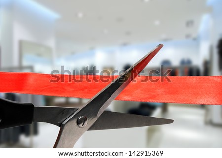 shop grand opening - cutting red ribbon Royalty-Free Stock Photo #142915369