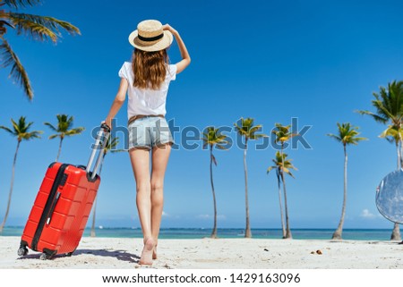 Woman red suitcase shorts journey tourism straw hat palm                           