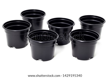 plastic black flowerpots on white background