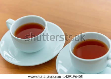 High Angle View Of Black Tea In Cup on Wooden Table