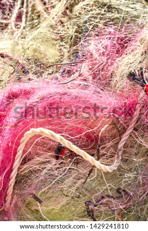 A tangled mess of fishing nets plastic rope and other debris washed up on a coastal beach. Save the Planet stock picture.