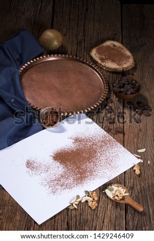 Hand held spoon, sprinkle coffee powder into paper