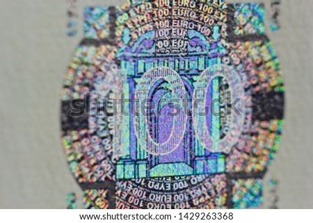 Protective watermark on a hundred euro bill in macro. protection against counterfeiting of banknotes. hologram. detail of paper money close up.