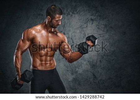 Muscular Men Lifting Weights. Studio Shot Royalty-Free Stock Photo #1429288742