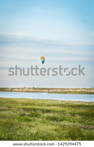 A man kitesurfing in the summer by the sea