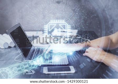 Businessman with computer background with technology theme hologram. Concept of hightech. Multi exposure.