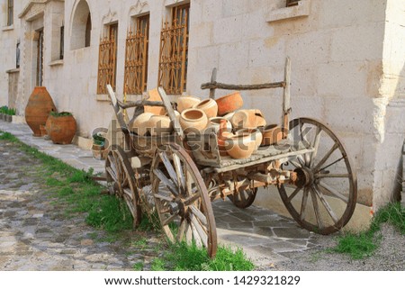 The photo was taken in Turkey, in the city of Uchisar. The picture shows an old cart loaded with ceramic dishes.