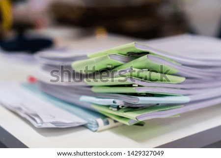 Stacks of piles unfinished papers documents files in accounting business report with green paper corner on desk in modern office, Paperwork of financial folder at business workplace concept