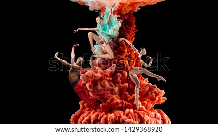 Abstract creative collage formed by color dissolving in water on black background. Bright combination of colors. Young dancers in clouds of smoke or dissolves. Graceful, flexibility and elegance.