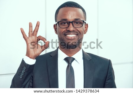 Happy African American Businessman in Eyeglasses. Confident Smiling Man Shows Ok Gesture. Good Job in Office.