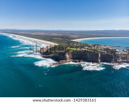 Drone picture of two huge beach in a coast with forest and city