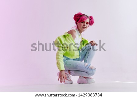 woman in stylish green jacket squats