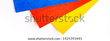 Three part of colourful sheets on white background. Blue, red and yellow blank cardboard. Concept for banner page