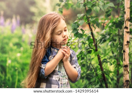 girl with lily of the valley in nature