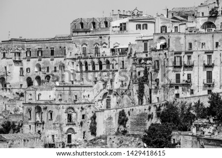 Old stones house buildings and ancient Italian village in Matera in Italy. Full picture of white buildings made with stones. Cluster of houses. Matera, Italy. Black and white.