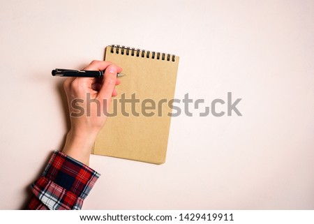 Man writing by left hand. Left hander day concept. Working place of lefty Royalty-Free Stock Photo #1429419911