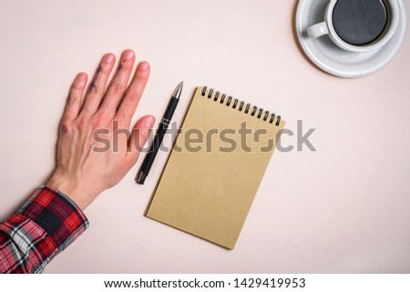 Left hand near note pad and coffee. Left hander day concept. Working place of lefty Royalty-Free Stock Photo #1429419953