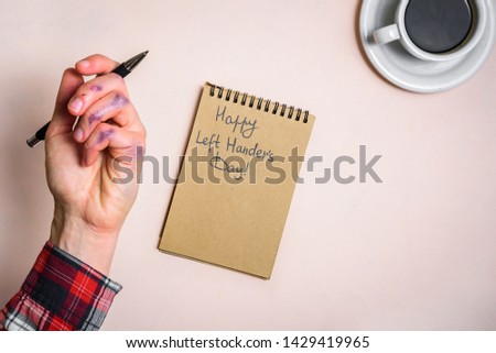 Dirty left hand after writing. Left hander day concept. Working place of lefty Royalty-Free Stock Photo #1429419965