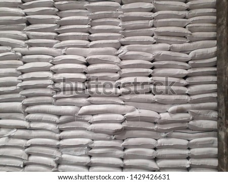 The product stock is packed in sacks, stacked in the warehouse, waiting for delivery.