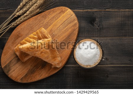 Concept of perfect breakfast in the morning. Coffee white cup and croissant for breakfast on wooden background on the table