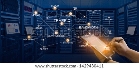 Network monitoring concept of administrator holding tablet computer with pen and connection of monitoring services and Data center room with server, networking devices and kvm monitors Royalty-Free Stock Photo #1429430411