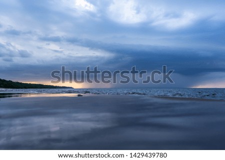 Sea coastal line at sunset. Amazing nature landscape with stormy sky.